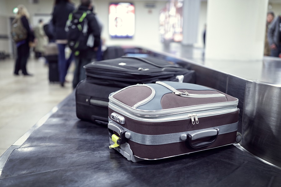 "suitcases on conveyor belt"